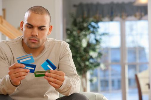 Man looking at credit cards