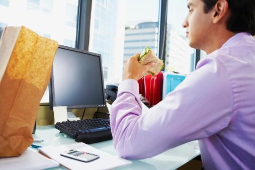 Step 2 to Financial Freedom - Stop Using Your Credit Cards - Man at Desk Eating