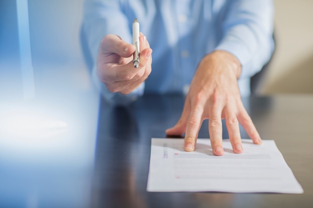 Signing paperwork with pen